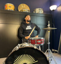 Load image into Gallery viewer, Stay warm in the &#39;JUST DRUM&#39; hoodie. A cozy choice for drummers, percussionists, and drumline enthusiasts who love stylish comfort.
